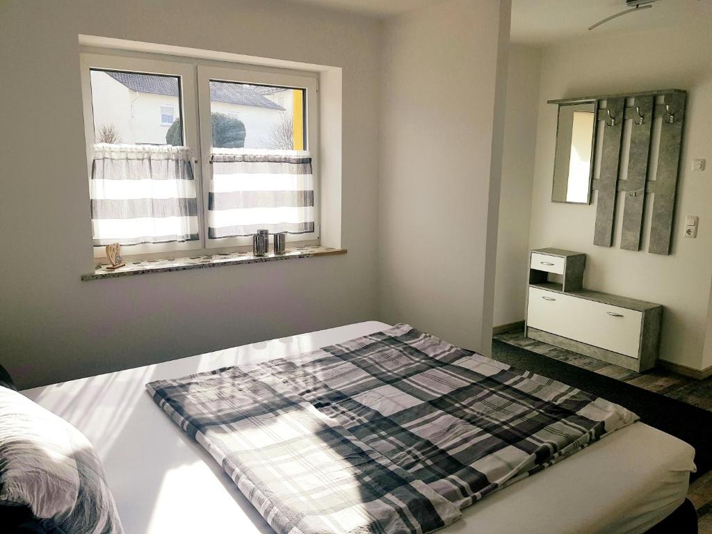 a bedroom with a bed and a window at Apartment Bad Salzschlirf in Bad Salzschlirf