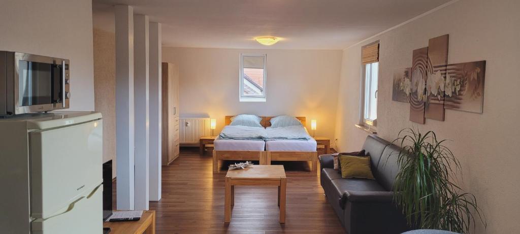 a living room with a couch and a bed at Ferienwohnung Orchidee am Neckar in Villingen-Schwenningen