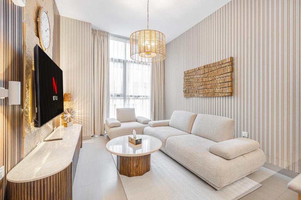 a living room with a couch and a table at 1BR Wow Apartment in Sharjah - Crystal Retreat in Sharjah Intl