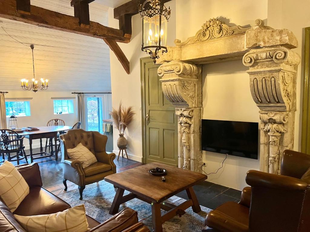 a living room with a large fireplace with a tv at Westgaerde20 in Dwingeloo