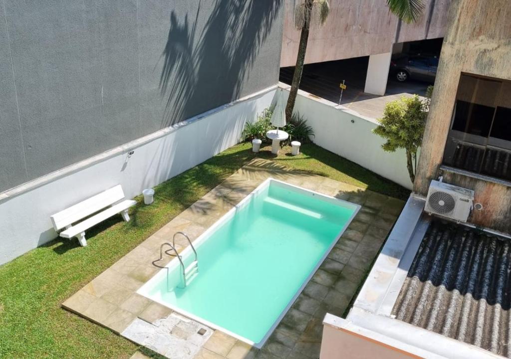 a swimming pool in the backyard of a building at 02 dormitórios - Até 06 pessoas in Torres