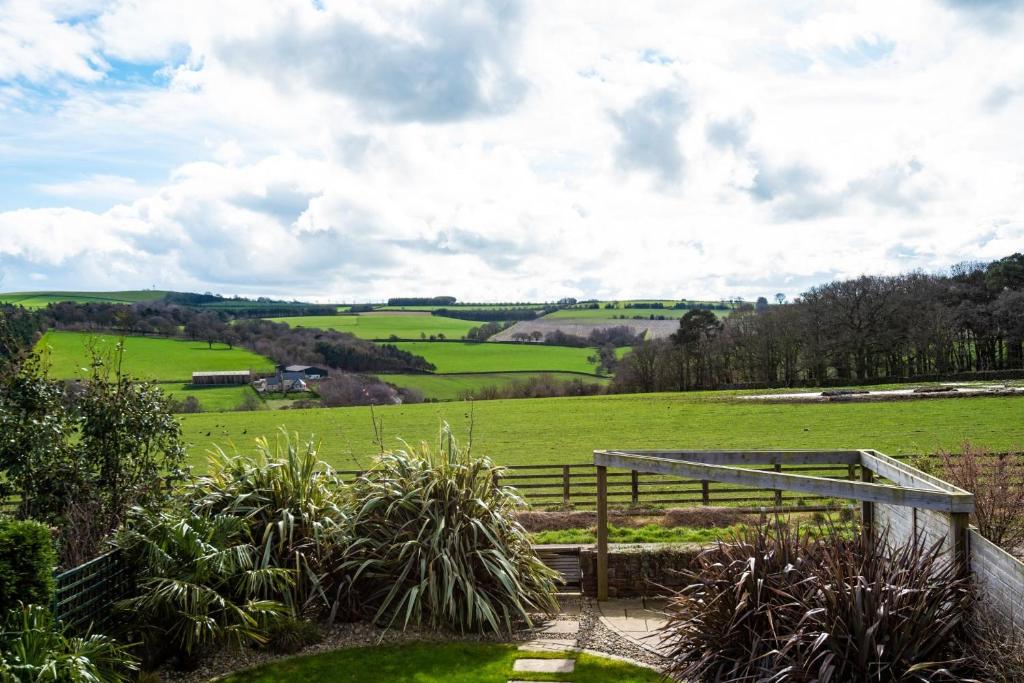 a view of a lush green field with a wooden gate at Number Nine in Lanchester