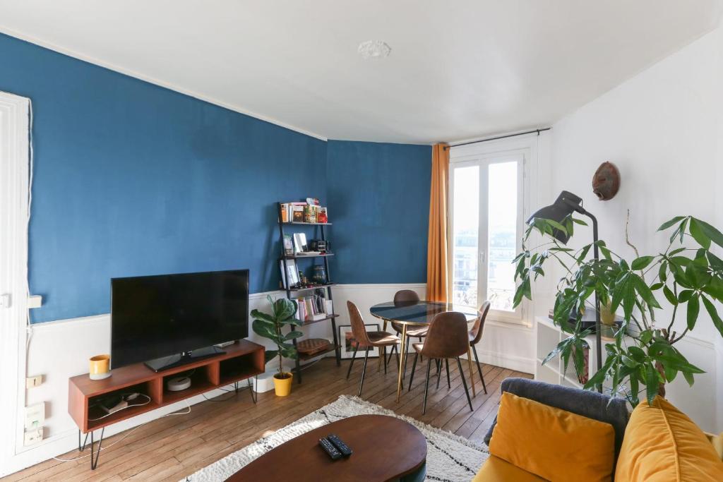 un salon avec un mur d'accent bleu dans l'établissement Nice T2 of 40 m close to Paris Parc André Citroën, à Paris