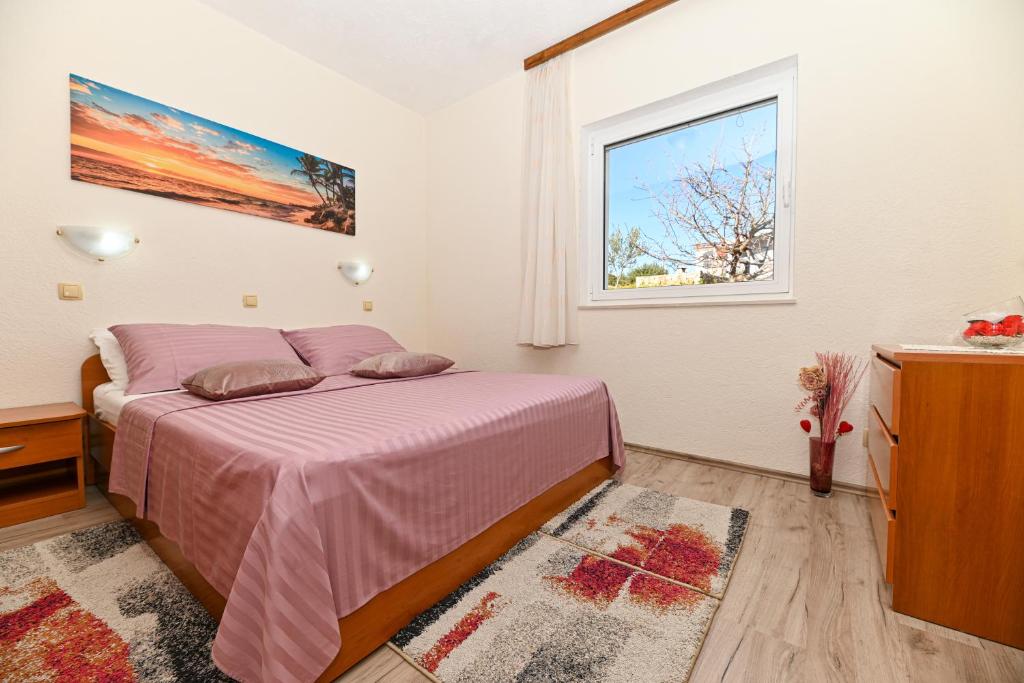 Postel nebo postele na pokoji v ubytování Apartments Patricia