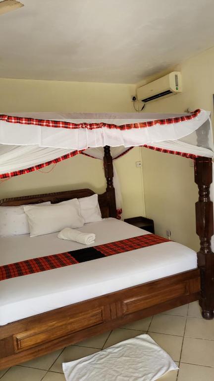 Postel nebo postele na pokoji v ubytování Maasai Resort