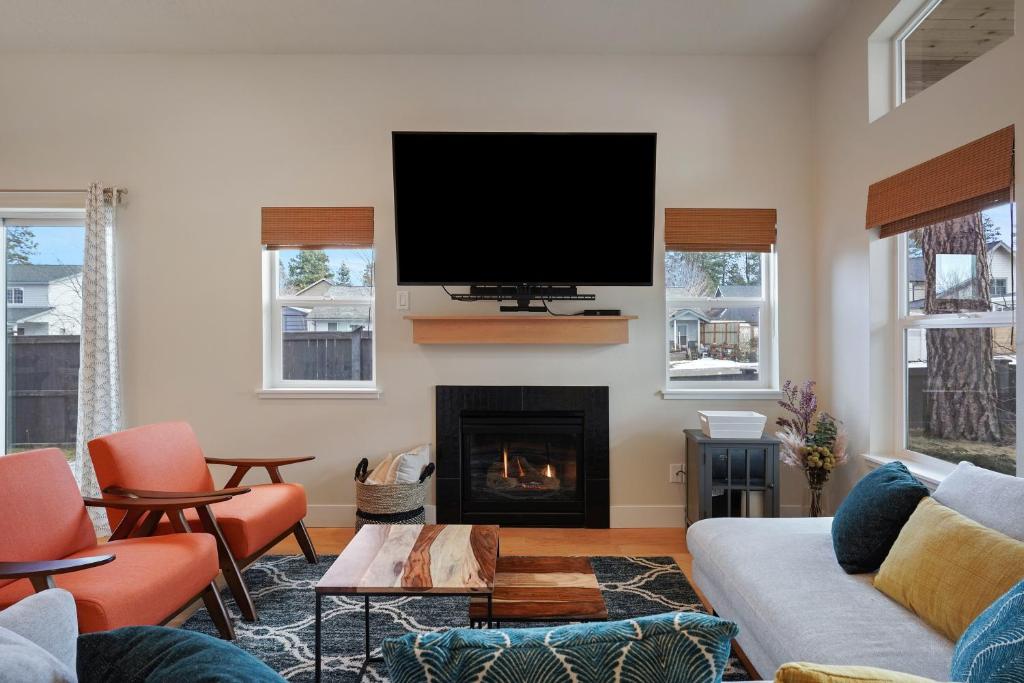 a living room with a tv and a fireplace at Dwell 30 Day Minimum in Bend