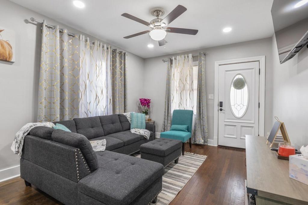 a living room with a couch and a ceiling fan at Lively Bungalow Retreat Near Belle Isle, RVA! in Richmond