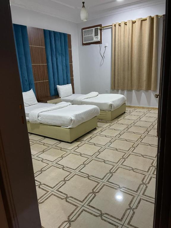 Postel nebo postele na pokoji v ubytování كــيــان الـمـنـسـك Kayan Al Mansak