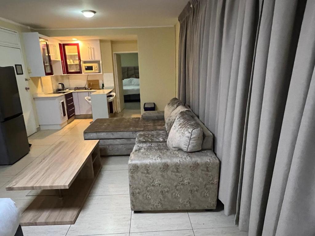 a living room with a couch and a table at Oceanic 108 in Durban