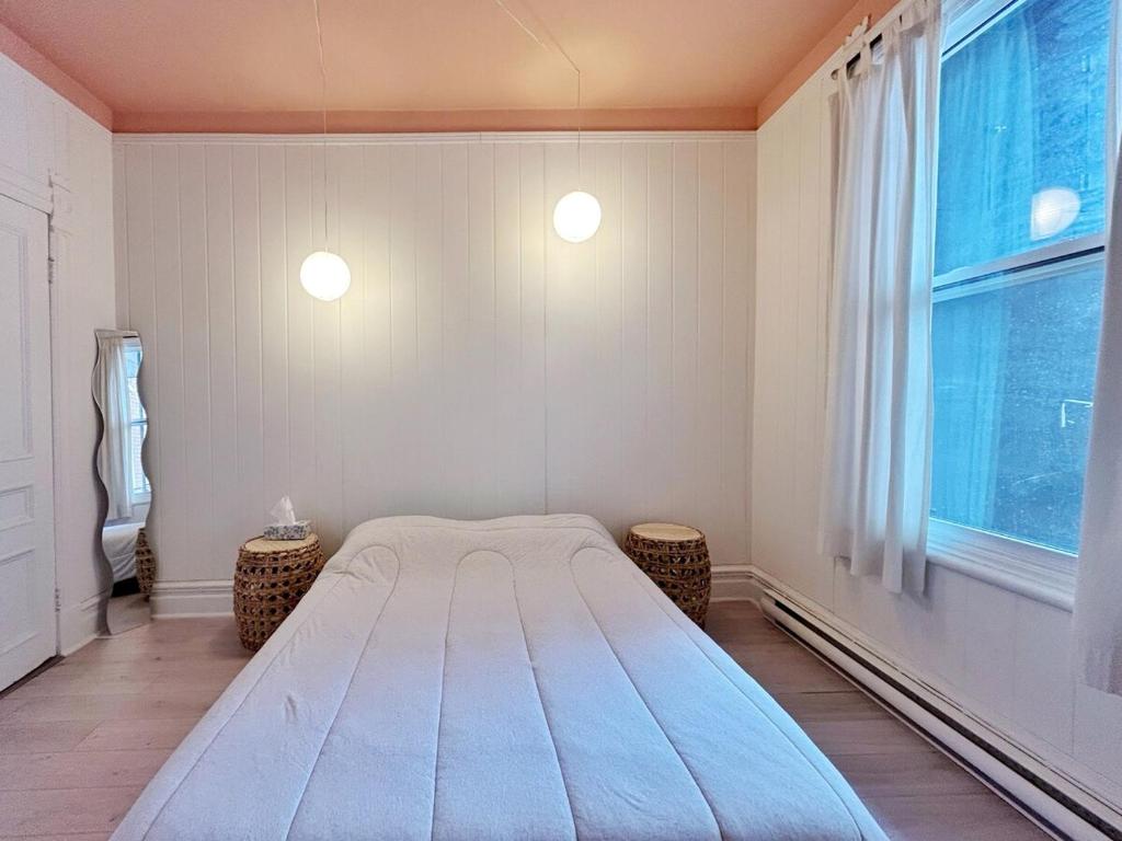 a bedroom with a large bed and a window at Bright and spacious appartment in Montreal
