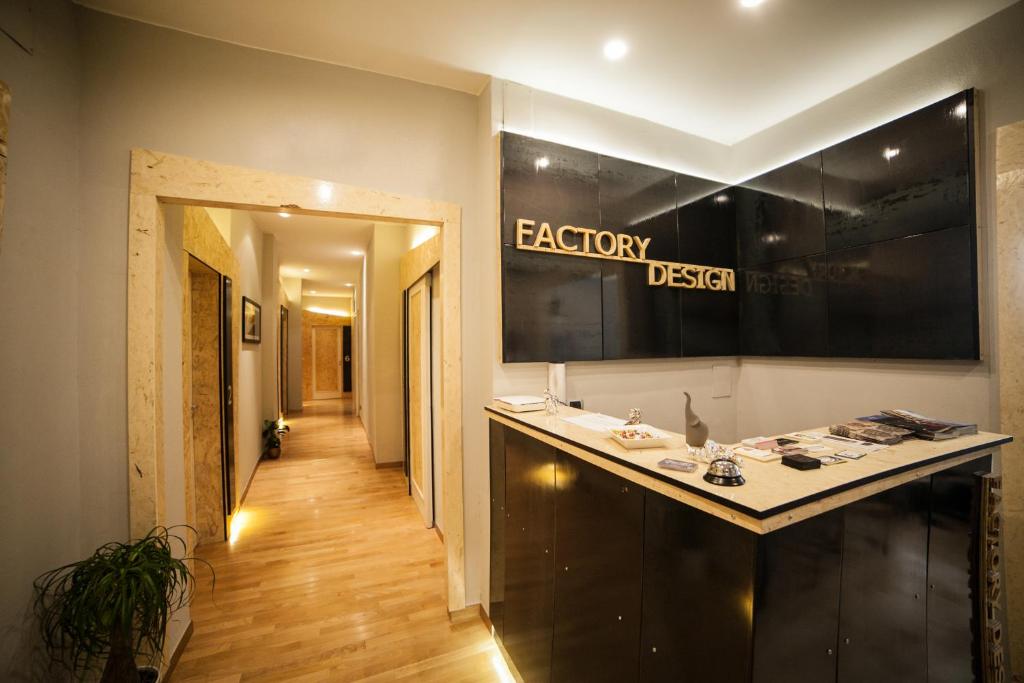 a bathroom with a counter with a sign on the wall at Factory Design in Naples