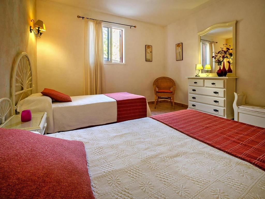 a bedroom with two beds and a dresser and a mirror at Malpais de Candelaria Villa with Pool in Bence