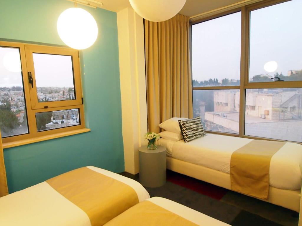 Uma cama ou camas num quarto em Grand Park Hotel Jerusalem