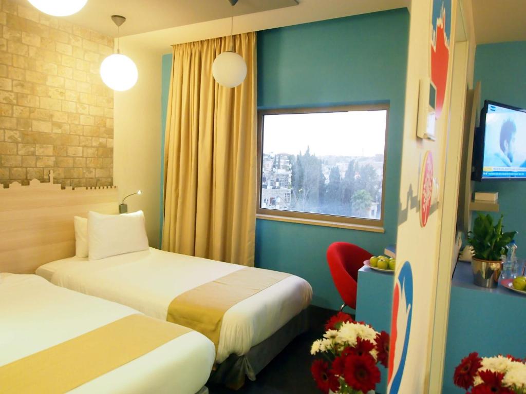 Uma cama ou camas num quarto em Grand Park Hotel Jerusalem