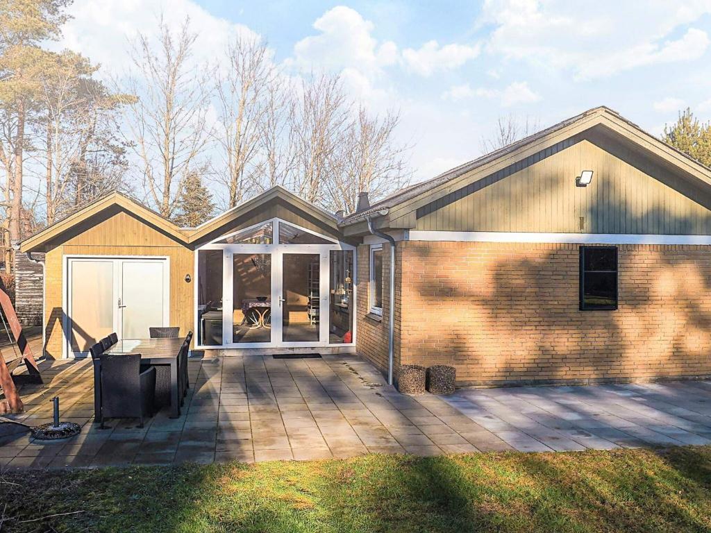 a house with a deck with a sliding glass door at 4 star holiday home in Hals in Hals