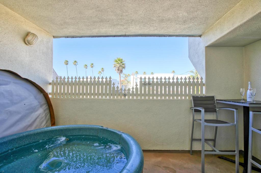 a tub in a room with a table and chairs at SeaVenture Beach Hotel in Pismo Beach