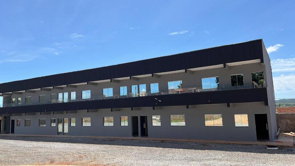 a large building with a black roof at Residencial Mangueiral in Paracatu