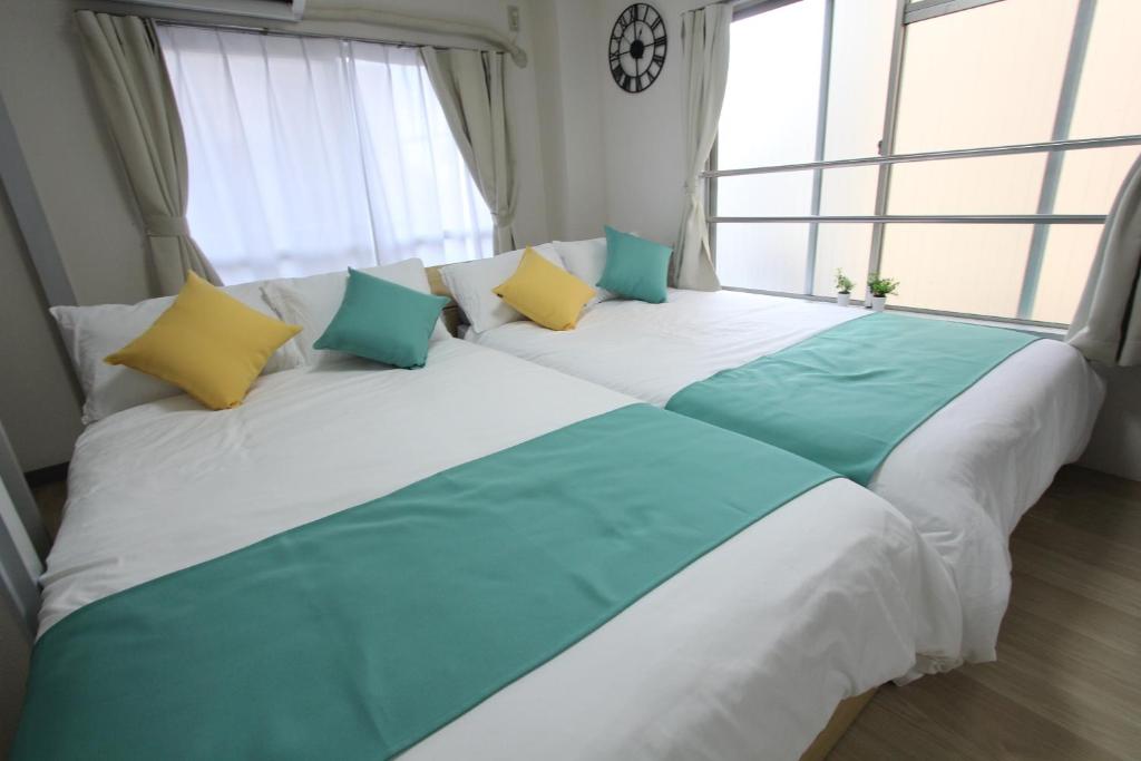 Postel nebo postele na pokoji v ubytování Hotel LUANA in Shin-Nakano