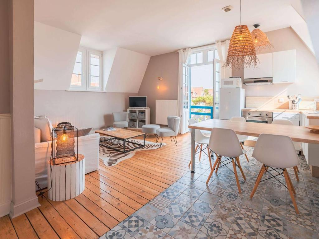 una cucina e un soggiorno con tavolo e sedie di Appartement moderne en centre-ville du Touquet avec 2 chambres - FR-1-821-28 a Le Touquet-Paris-Plage