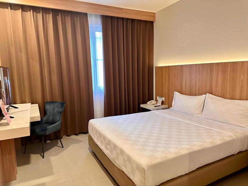 Postel nebo postele na pokoji v ubytování Royal Palm Hotel & Conference Center Cengkareng