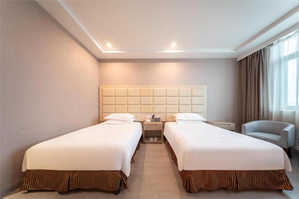 Postel nebo postele na pokoji v ubytování Rezen Select Shanghai International Resort