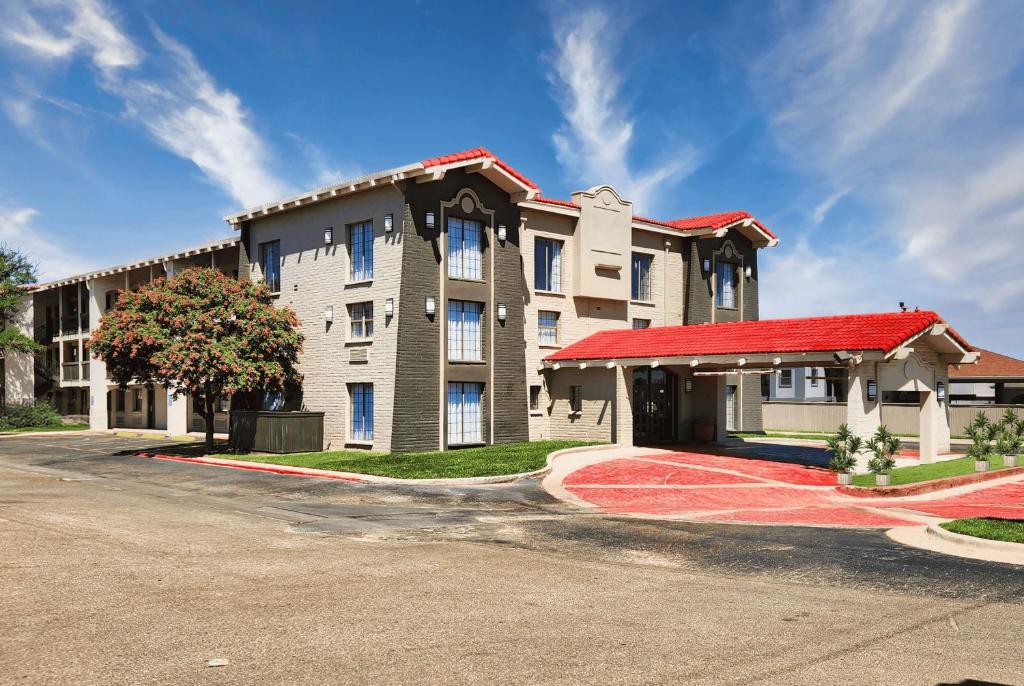 a large building with a red roof on a street at La Quinta Inn by Wyndham Amarillo West Medical Center in Amarillo