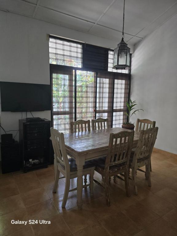 a dining room with a wooden table and chairs at Holiday Rental Mattegoda Sri Lanka in Mattegoda