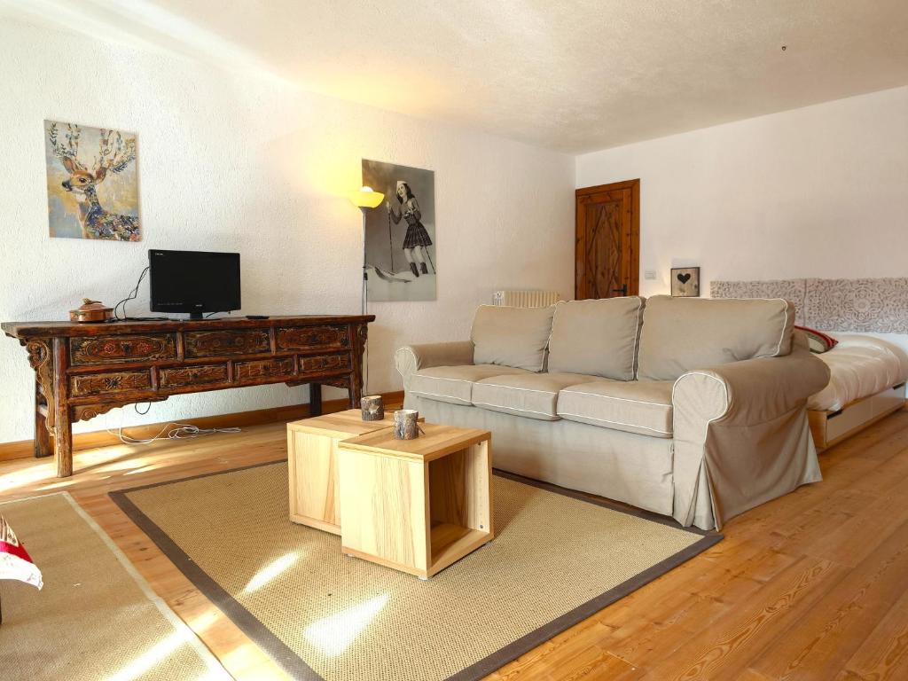 a living room with a couch and a table at Hostdomus - Castle Apartments in Bessé-Bas