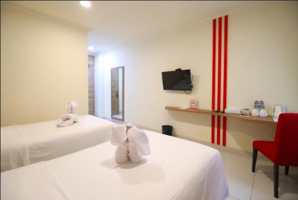 Postel nebo postele na pokoji v ubytování Moritz Hotel RSAB Harapan Kita
