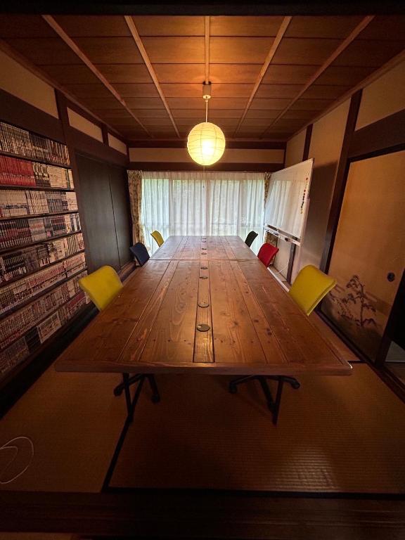 YamakamiにあるGuest House DETARAMESOの椅子付きの部屋内の大きな木製テーブル