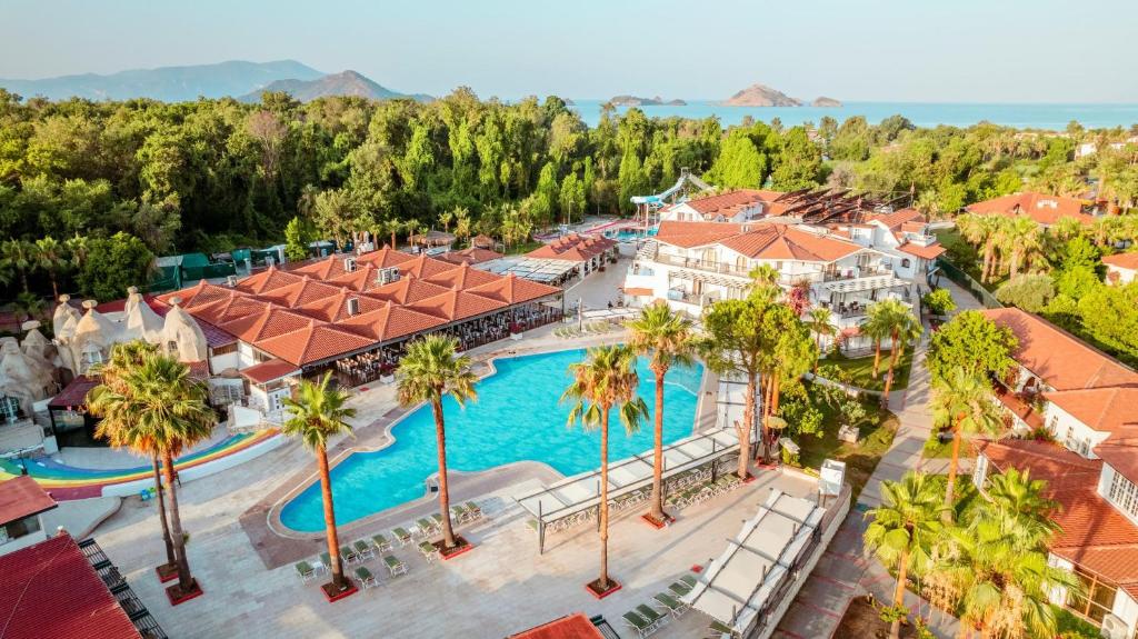 an aerial view of a resort with a pool and palm trees at Lykia Botanika Beach Fun & Club - All Inclusive in Fethiye