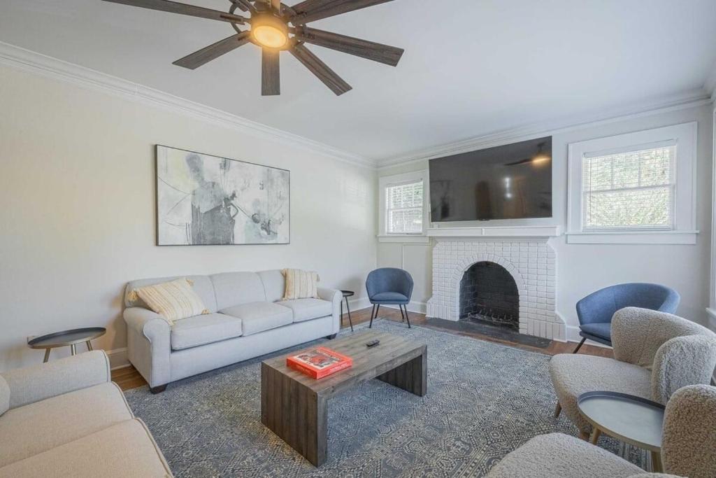 a living room with a couch and a fireplace at Five Points Mill House in Athens