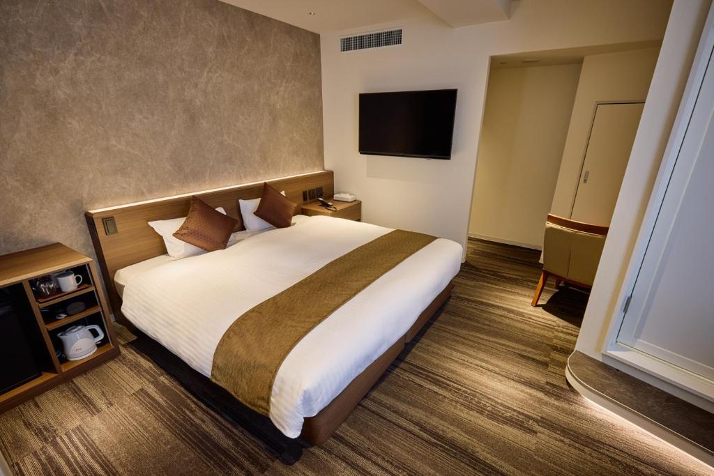 Postel nebo postele na pokoji v ubytování Ginza International Hotel
