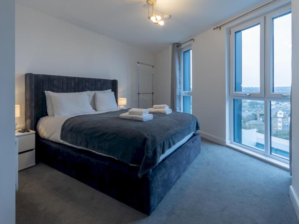 a bedroom with a bed with two towels on it at Pass the Keys Penthouse apartment Stunning Views in Chelmsford