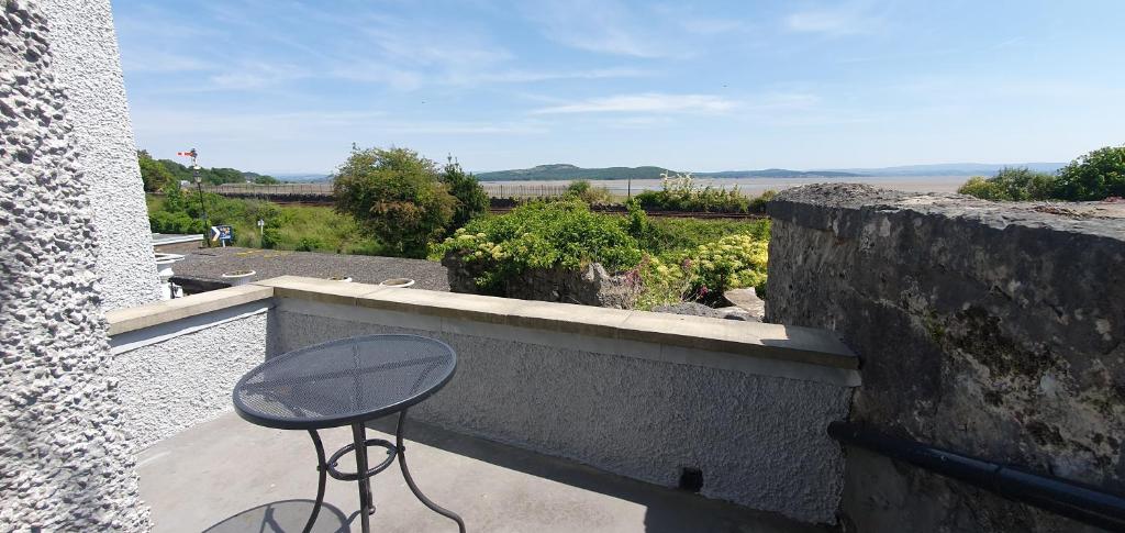 a stool sitting on the balcony of a house at Ivy's in Grange Over Sands