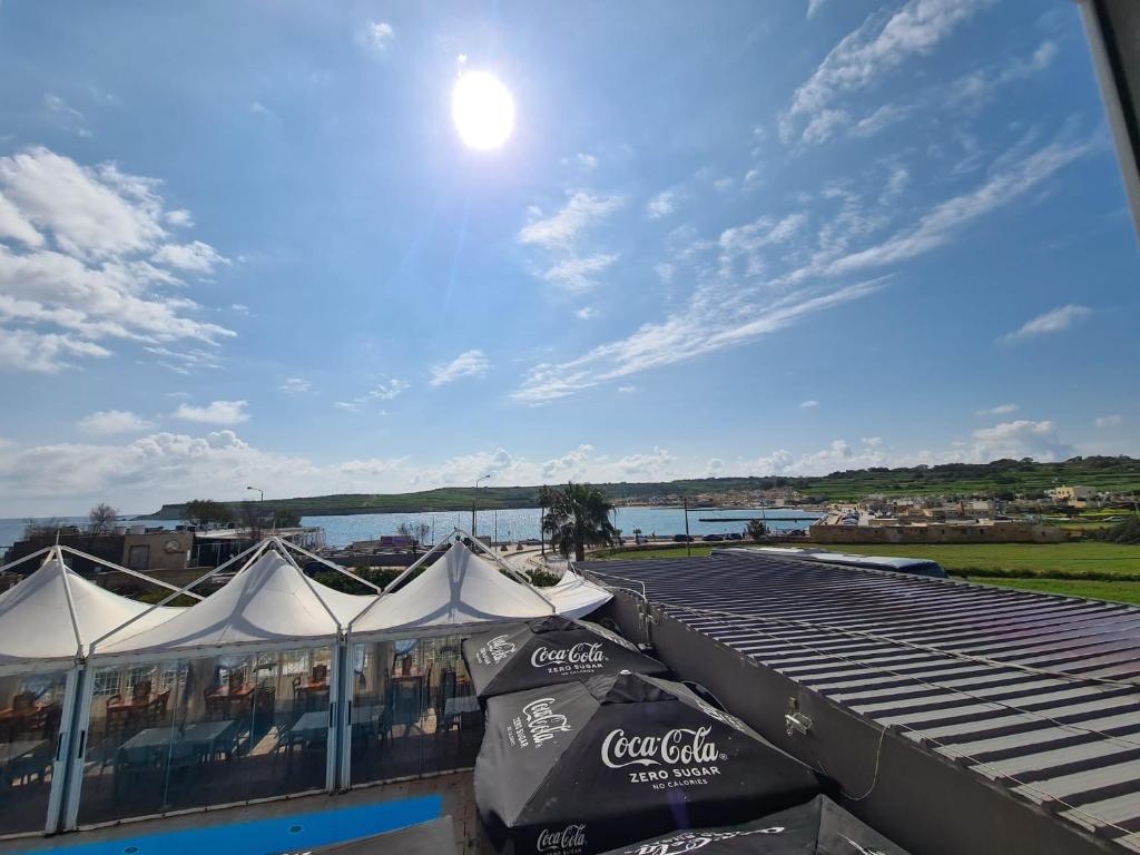 a view from the roof of a restaurant with tents at Sensi Hotel in Marsaskala