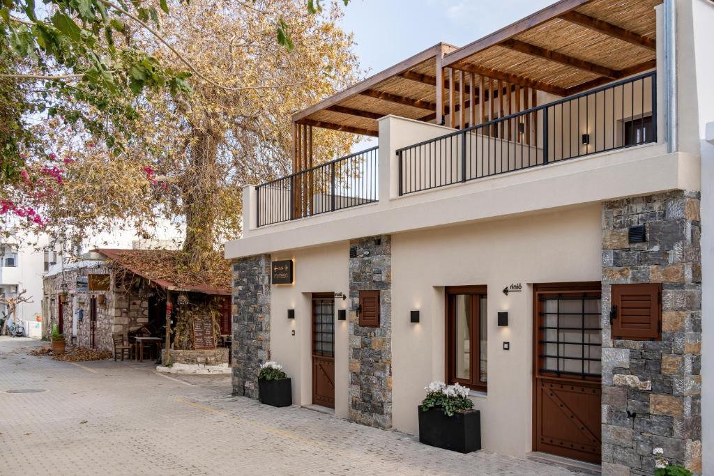a house with a balcony on top of it at Casa Myrtēssa in Myrtos