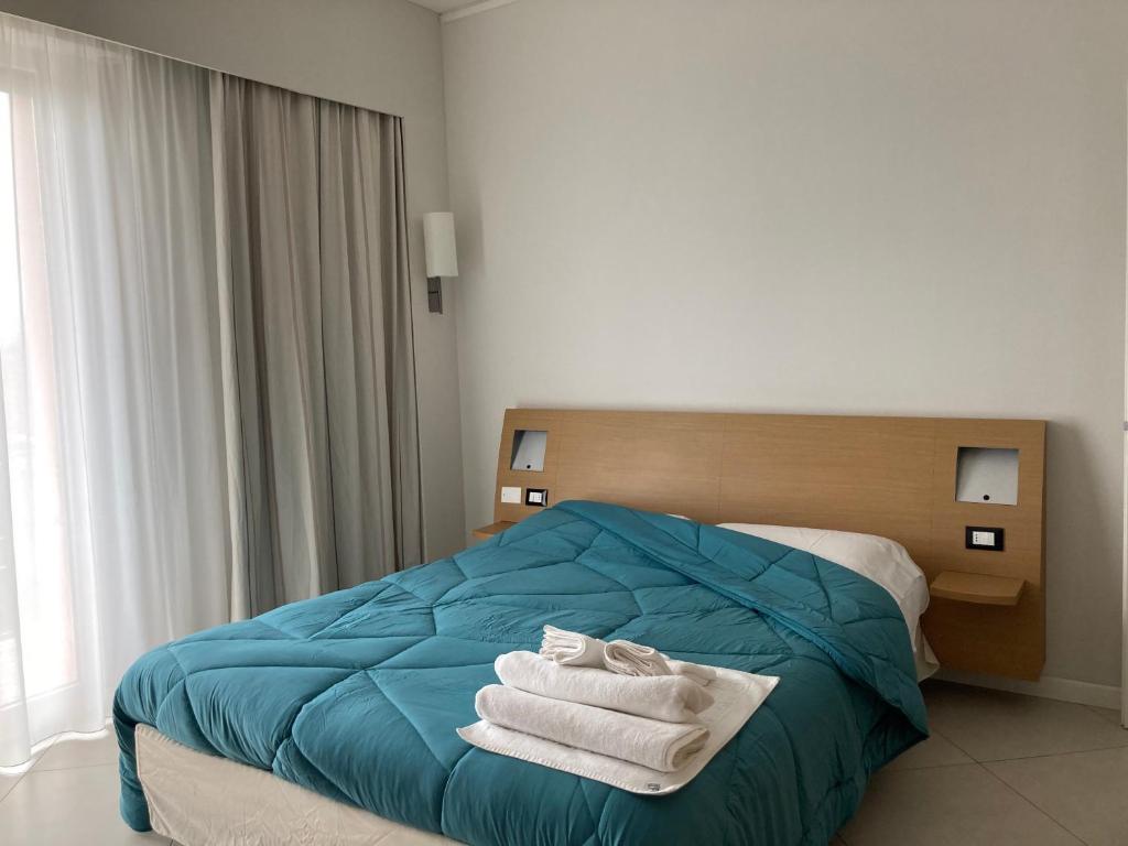 a bedroom with a bed with towels on it at Home & B in Arezzo