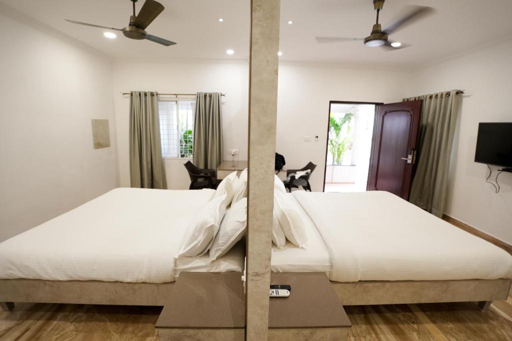 Postel nebo postele na pokoji v ubytování Avenue 11 Boutique Residences, Poes Garden Chennai