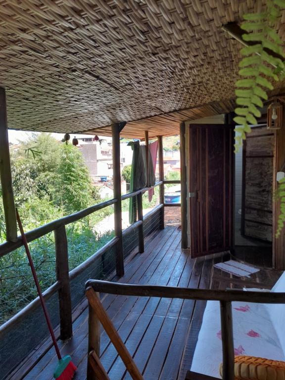 a porch of a house with a wooden deck at Chalé Bambu3 in Cunha