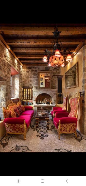 a living room with two couches and a fireplace at Nikos Takis Boutique Fashion hotel in Rhodes Town