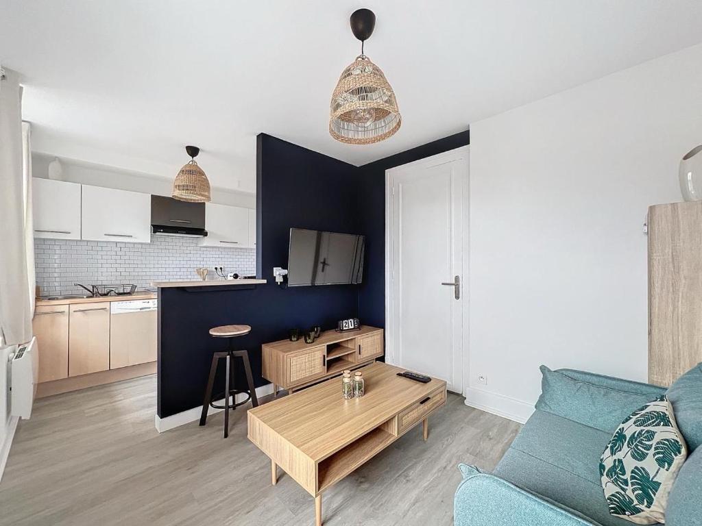 un salon avec un canapé et une table dans l'établissement les Toits de Belfort ville, à Belfort