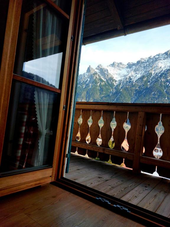 a room with a window with a view of mountains at Haus Sonnenruh in Mittenwald