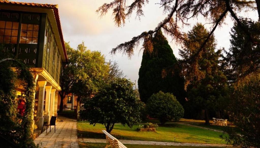 a view of a house with a tree and a yard at Hotel Rural VN Casal in Pontevedra