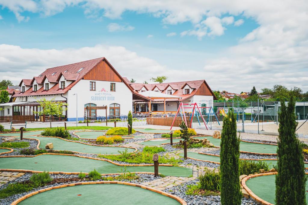 a park with a playground and a building at Slovácký dvůr s.r.o. in Ostrožská Nová Ves