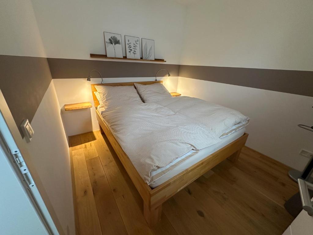 a bedroom with a white bed with a light on it at Charmantes Quartier im Herzen der Altstadt in Mönchengladbach