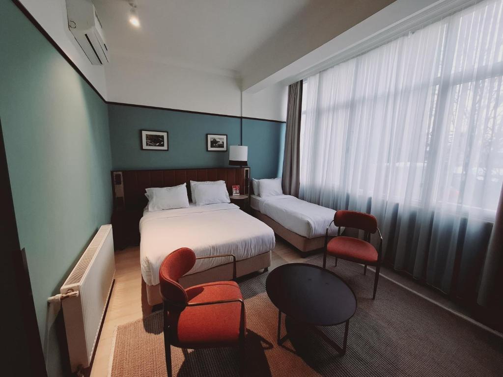 A bed or beds in a room at EA Exclusive Hotel