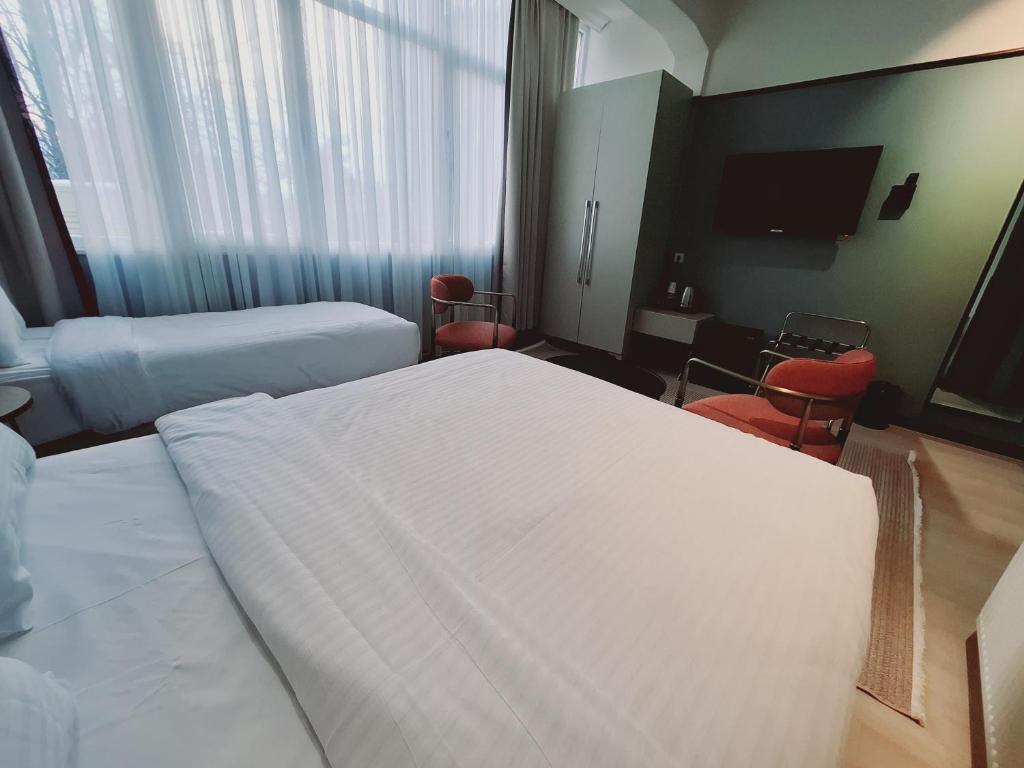 A bed or beds in a room at EA Exclusive Hotel
