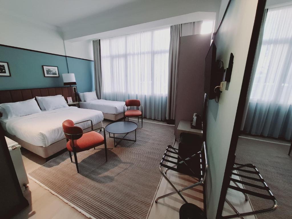 A bed or beds in a room at EA Exclusive Hotel