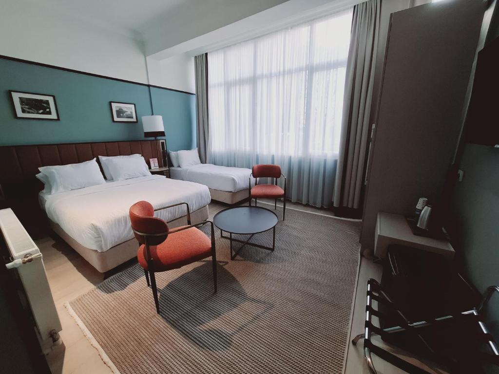 A bed or beds in a room at EA Exclusive Hotel